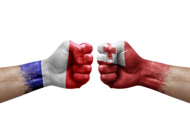 Two hands punch to each others on white background. Country flags painted fists, conflict crisis concept between france and tonga