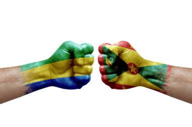Two hands punch to each others on white background. Country flags painted fists, conflict crisis concept between gabon and grenada