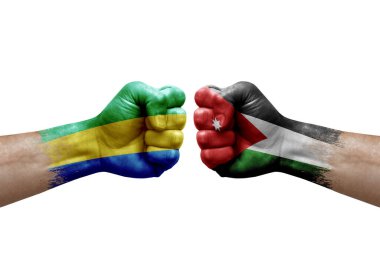 Two hands punch to each others on white background. Country flags painted fists, conflict crisis concept between gabon and jordan