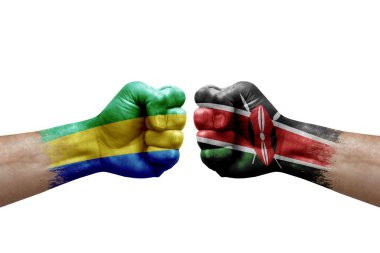 Two hands punch to each others on white background. Country flags painted fists, conflict crisis concept between gabon and kenya