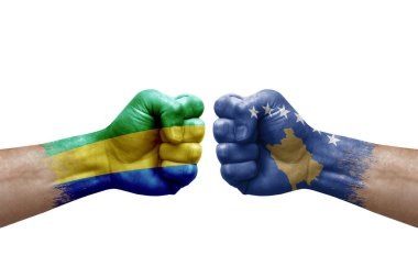 Two hands punch to each others on white background. Country flags painted fists, conflict crisis concept between gabon and kosovo
