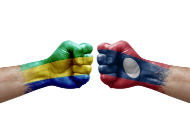 Two hands punch to each others on white background. Country flags painted fists, conflict crisis concept between gabon and laos