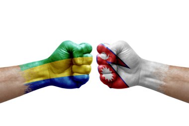 Two hands punch to each others on white background. Country flags painted fists, conflict crisis concept between gabon and nepal