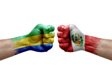 Two hands punch to each others on white background. Country flags painted fists, conflict crisis concept between gabon and peru