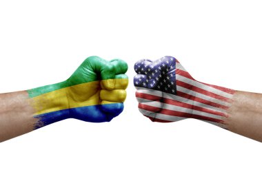 Two hands punch to each others on white background. Country flags painted fists, conflict crisis concept between gabon and usa