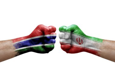 Two hands punch to each others on white background. Country flags painted fists, conflict crisis concept between gambia and iran