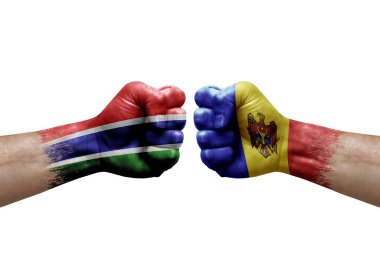 Two hands punch to each others on white background. Country flags painted fists, conflict crisis concept between gambia and moldova