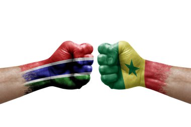 Two hands punch to each others on white background. Country flags painted fists, conflict crisis concept between gambia and senegal