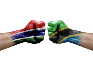 Two hands punch to each others on white background. Country flags painted fists, conflict crisis concept between gambia and tanzania
