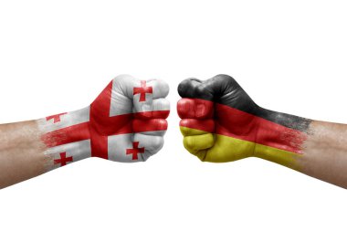 Two hands punch to each others on white background. Country flags painted fists, conflict crisis concept between georgia and germany