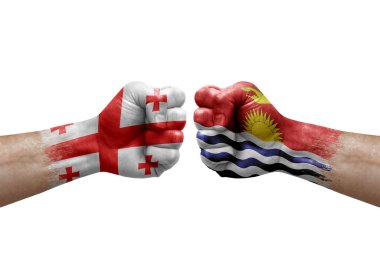Two hands punch to each others on white background. Country flags painted fists, conflict crisis concept between georgia and kiribati