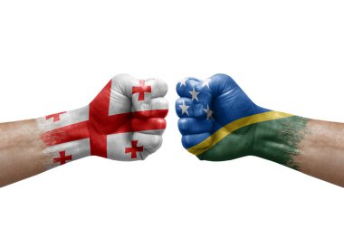 Two hands punch to each others on white background. Country flags painted fists, conflict crisis concept between georgia and solomon islands