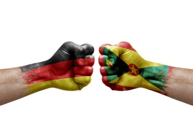 Two hands punch to each others on white background. Country flags painted fists, conflict crisis concept between germany and grenada