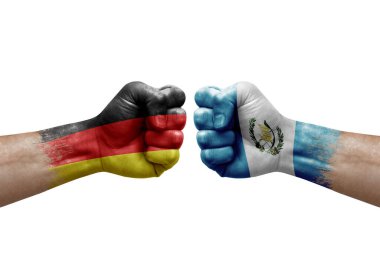 Two hands punch to each others on white background. Country flags painted fists, conflict crisis concept between germany and guatemala