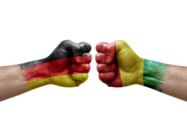 Two hands punch to each others on white background. Country flags painted fists, conflict crisis concept between germany and guinea