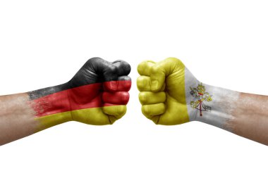 Two hands punch to each others on white background. Country flags painted fists, conflict crisis concept between germany and holy see