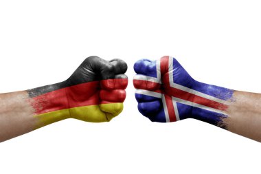 Two hands punch to each others on white background. Country flags painted fists, conflict crisis concept between germany and iceland