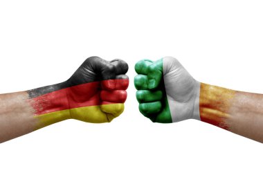 Two hands punch to each others on white background. Country flags painted fists, conflict crisis concept between germany and ireland