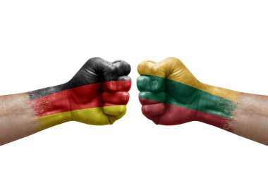 Two hands punch to each others on white background. Country flags painted fists, conflict crisis concept between germany and lithuania