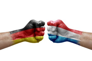 Two hands punch to each others on white background. Country flags painted fists, conflict crisis concept between germany and luxembourg