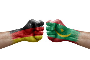 Two hands punch to each others on white background. Country flags painted fists, conflict crisis concept between germany and mauritania