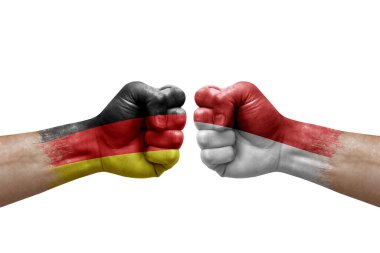 Two hands punch to each others on white background. Country flags painted fists, conflict crisis concept between germany and monaco