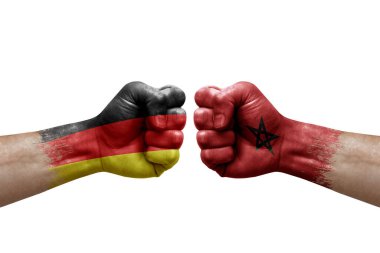 Two hands punch to each others on white background. Country flags painted fists, conflict crisis concept between germany and morocco