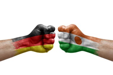 Two hands punch to each others on white background. Country flags painted fists, conflict crisis concept between germany and niger