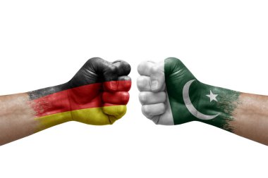 Two hands punch to each others on white background. Country flags painted fists, conflict crisis concept between germany and pakistan