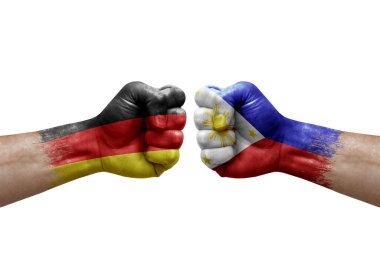 Two hands punch to each others on white background. Country flags painted fists, conflict crisis concept between germany and philippines