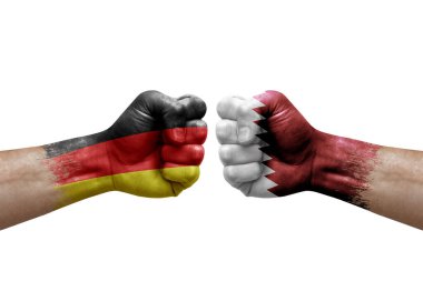 Two hands punch to each others on white background. Country flags painted fists, conflict crisis concept between germany and qatar