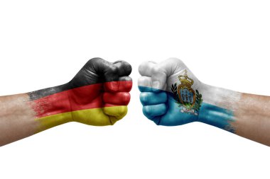 Two hands punch to each others on white background. Country flags painted fists, conflict crisis concept between germany and san marino