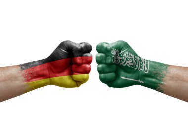 Two hands punch to each others on white background. Country flags painted fists, conflict crisis concept between germany and saudi arabia