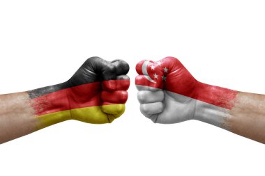 Two hands punch to each others on white background. Country flags painted fists, conflict crisis concept between germany and singapore