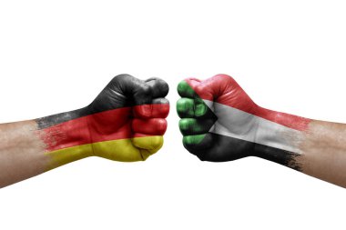 Two hands punch to each others on white background. Country flags painted fists, conflict crisis concept between germany and sudan