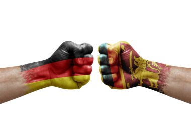 Two hands punch to each others on white background. Country flags painted fists, conflict crisis concept between germany and sri lanka