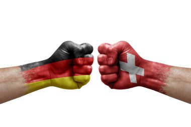 Two hands punch to each others on white background. Country flags painted fists, conflict crisis concept between germany and switzerland