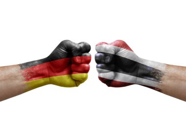 Two hands punch to each others on white background. Country flags painted fists, conflict crisis concept between germany and thailand