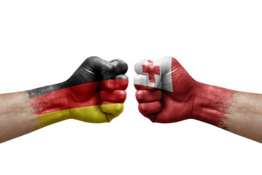 Two hands punch to each others on white background. Country flags painted fists, conflict crisis concept between germany and tonga