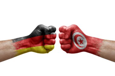 Two hands punch to each others on white background. Country flags painted fists, conflict crisis concept between germany and tunisia