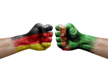 Two hands punch to each others on white background. Country flags painted fists, conflict crisis concept between germany and turkmenistan
