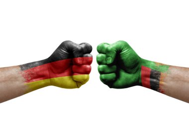 Two hands punch to each others on white background. Country flags painted fists, conflict crisis concept between germany and zambia
