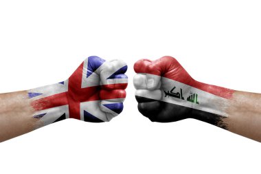 Two hands punch to each others on white background. Country flags painted fists, conflict crisis concept between great britain and iraq