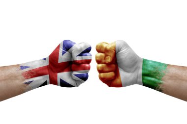 Two hands punch to each others on white background. Country flags painted fists, conflict crisis concept between great britain and ivory coast