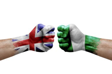 Two hands punch to each others on white background. Country flags painted fists, conflict crisis concept between great britain and nigeria