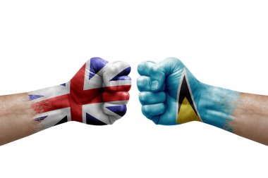 Two hands punch to each others on white background. Country flags painted fists, conflict crisis concept between great britain and saint lucia
