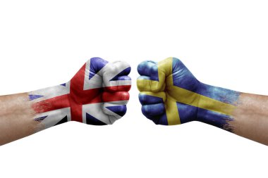Two hands punch to each others on white background. Country flags painted fists, conflict crisis concept between great britain and sweden