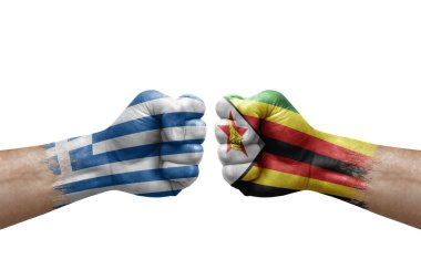 Two hands punch to each others on white background. Country flags painted fists, conflict crisis concept between greece and zimbabwe