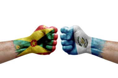 Two hands punch to each others on white background. Country flags painted fists, conflict crisis concept between grenada and guatemala
