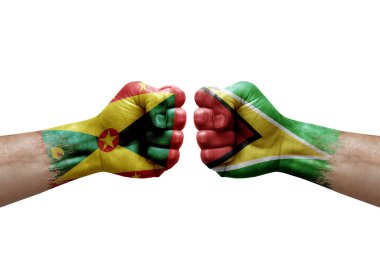 Two hands punch to each others on white background. Country flags painted fists, conflict crisis concept between grenada and guyana